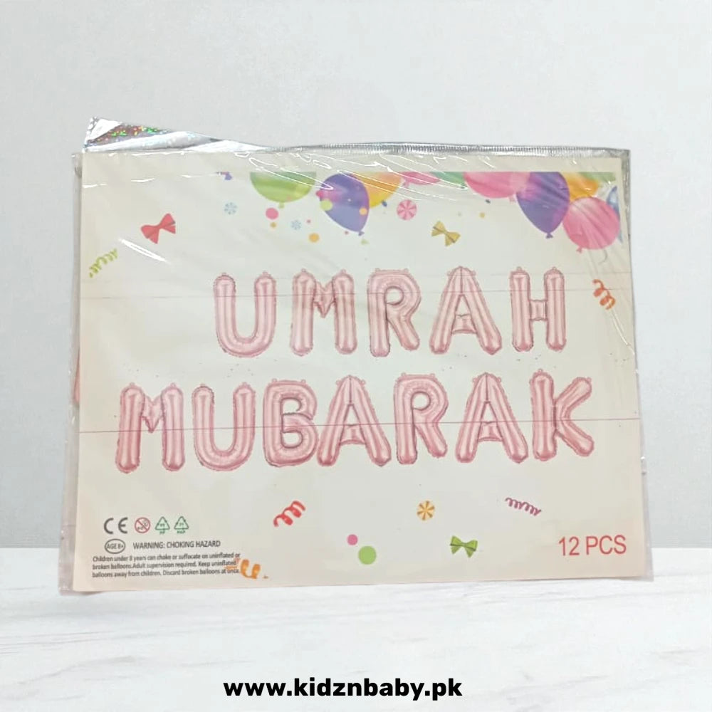 Close-up of sleek black and gold Umrah Mubarak banner foil balloons for photo backdrop