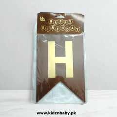 Packaged gold letter 'H' with 'Happy Birthday' banner on brown packaging against a white background.