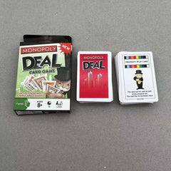 Monopoly Deal card game packaging and cards on a gray background