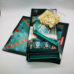 Scrabble board game set with tiles and packaging on a white surface
