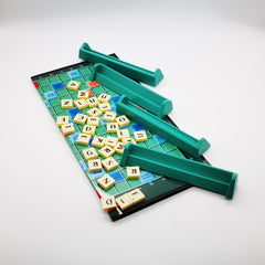 Board game with letter tiles and green stands on a white background