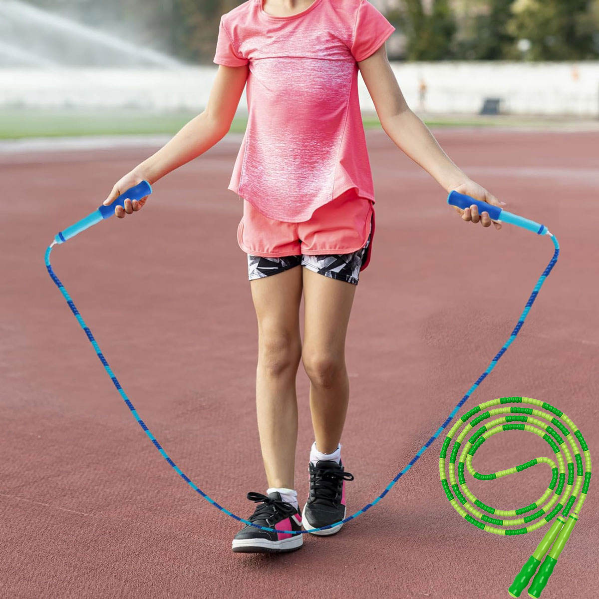 Person holding a blue jump rope on a track