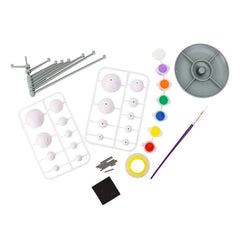 Art supply kit with tools, paints, and molds on a white background
