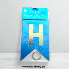 Blue birthday banner with gold letter 'H' and ring, packaging on a white background