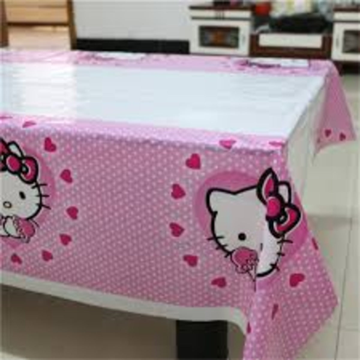 Hello Kitty plastic table cover with pink heart and polka dot design

